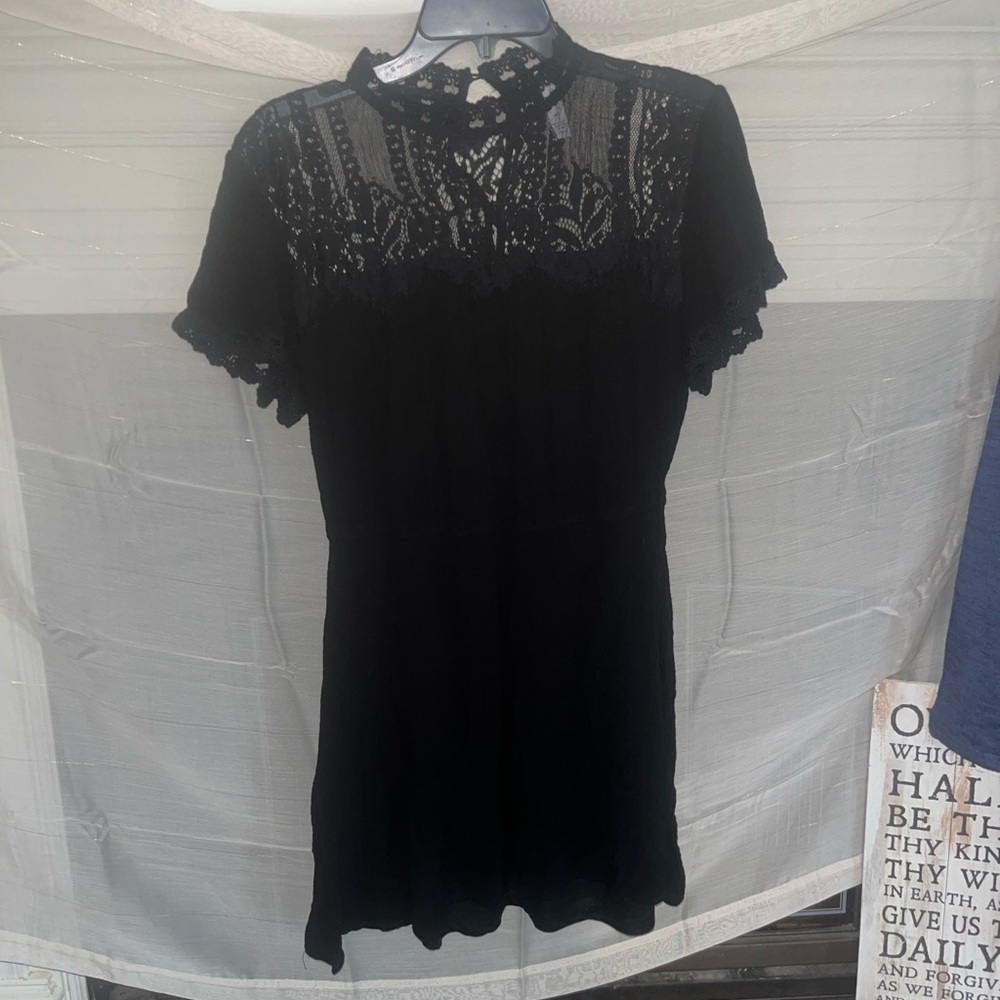 Beautiful black dress with lace detailing in front and back of dress.